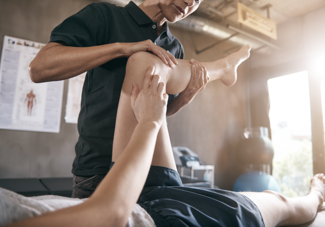 physical therapist preforming muscle therapy